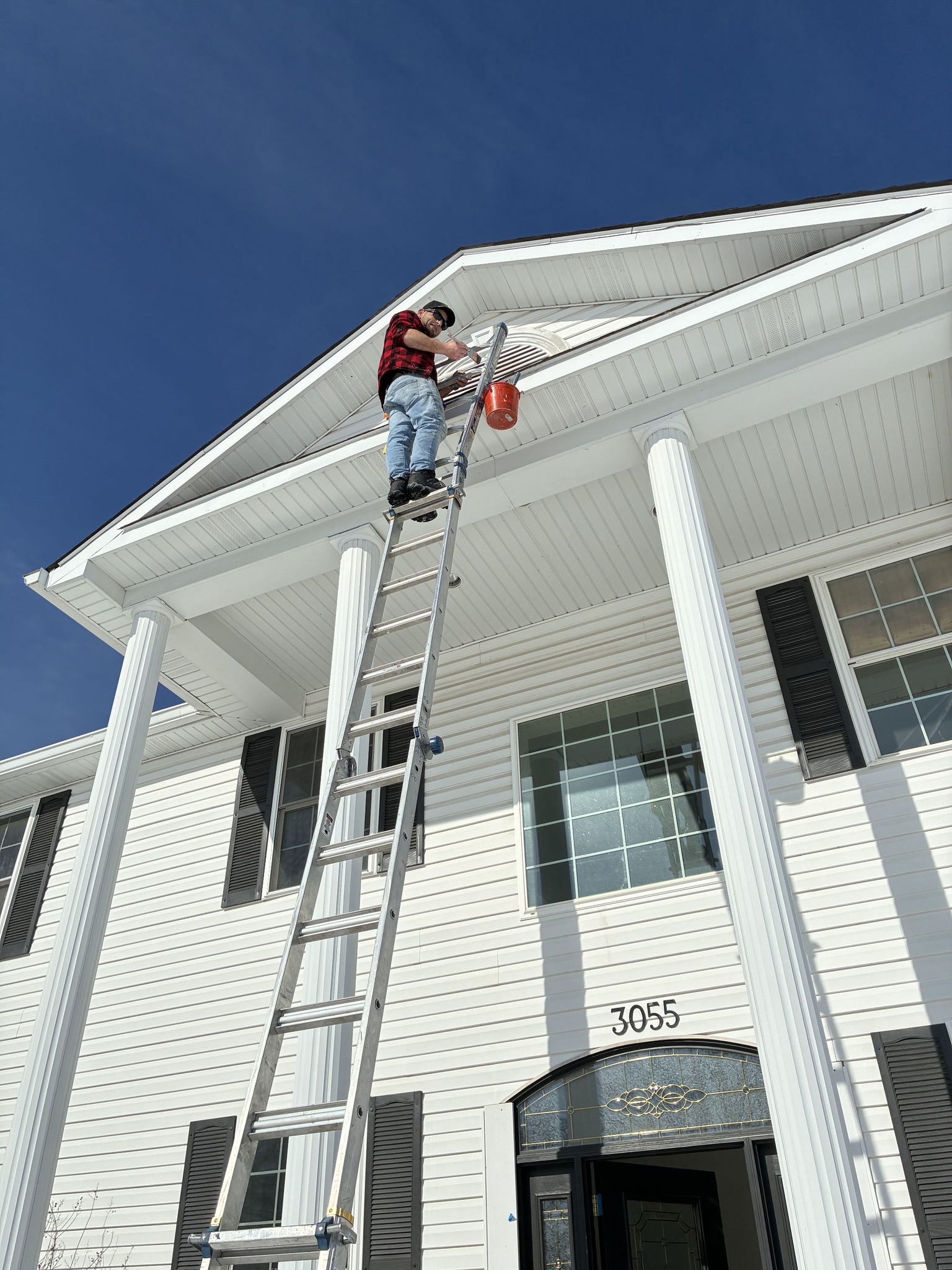 Exterior house painting project with refreshed siding